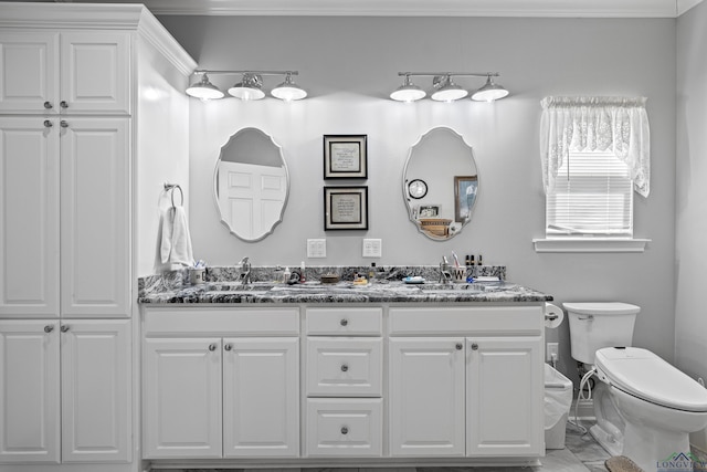 bathroom with vanity, ornamental molding, and toilet