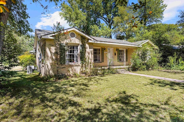 single story home with covered porch and a front yard