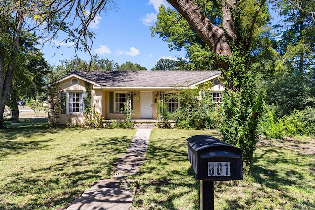 ranch-style home with a porch and a front lawn