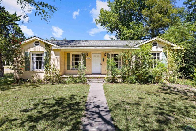 single story home with a front yard and a porch