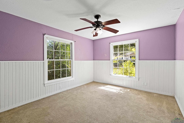 carpeted empty room with ceiling fan