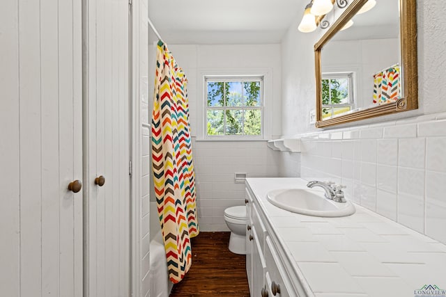 bathroom featuring hardwood / wood-style flooring, toilet, vanity, and a shower with shower curtain