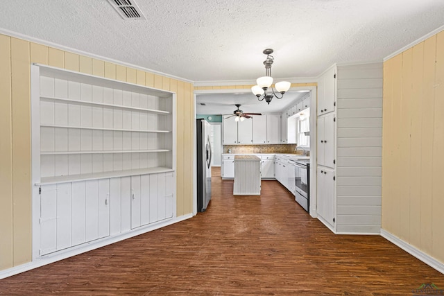 kitchen featuring pendant lighting, white cabinets, sink, dark hardwood / wood-style flooring, and stainless steel appliances