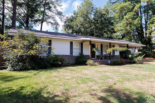 ranch-style house with covered porch and a front yard