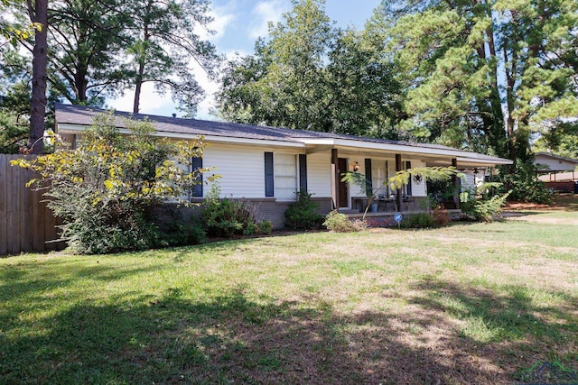 ranch-style home with covered porch and a front yard