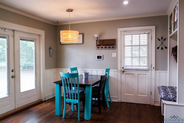 dining space featuring crown molding and dark wood-type flooring