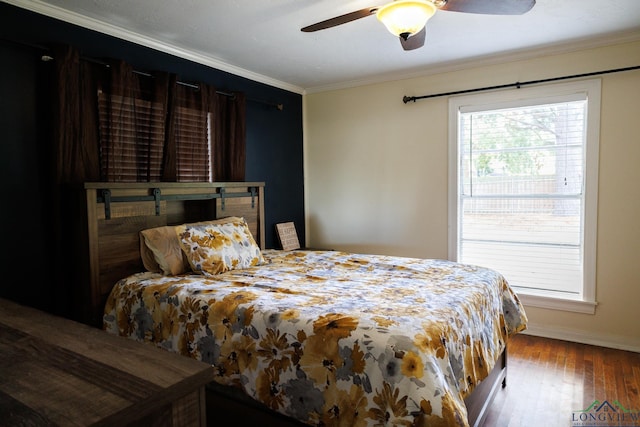 bedroom featuring hardwood / wood-style flooring, ceiling fan, and ornamental molding