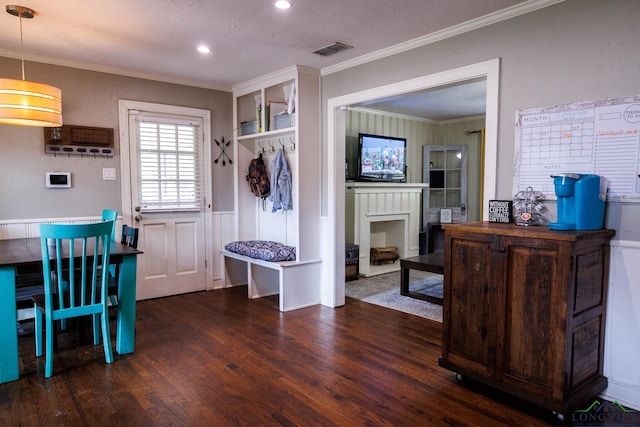 interior space with dark hardwood / wood-style floors, ornamental molding, and a textured ceiling