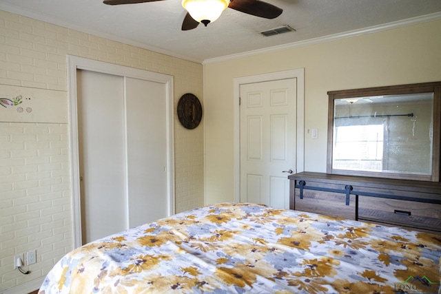 bedroom featuring ceiling fan, brick wall, and ornamental molding