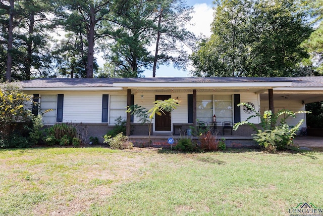 ranch-style home featuring a carport, covered porch, and a front yard