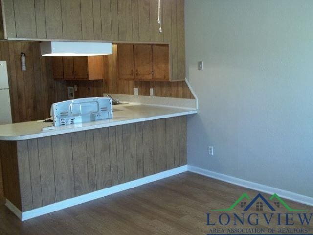 kitchen featuring dark hardwood / wood-style floors and kitchen peninsula