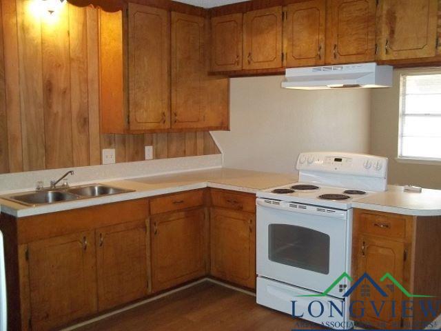 kitchen with dark hardwood / wood-style floors, sink, kitchen peninsula, and white electric stove