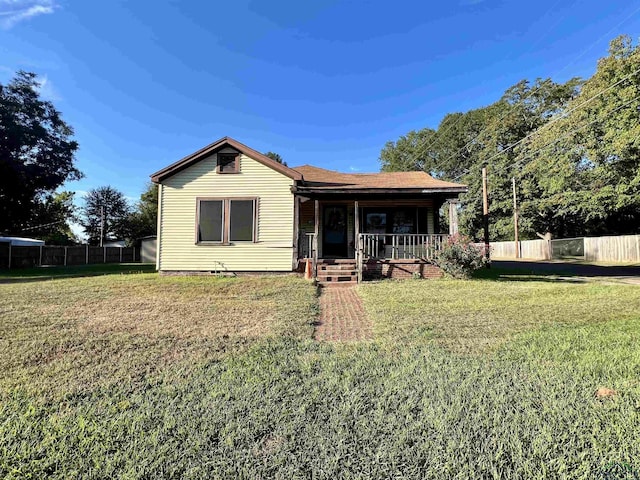 rear view of house with a yard and covered porch