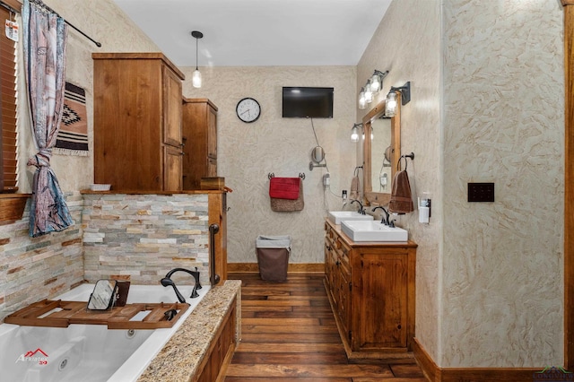 bathroom featuring a bathing tub, vanity, and wood-type flooring