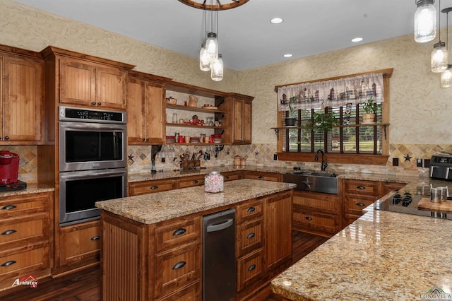 kitchen with pendant lighting, a kitchen island, stainless steel double oven, and sink