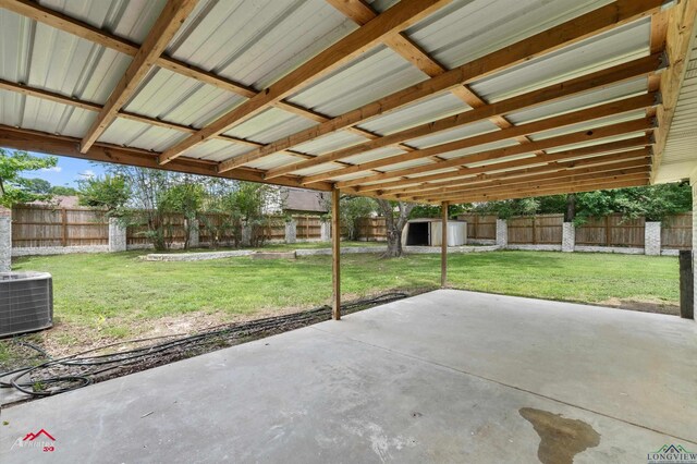 404 Pinewood, Marshall, TX 75672 - fenced backyard with a patio and a storage unit
