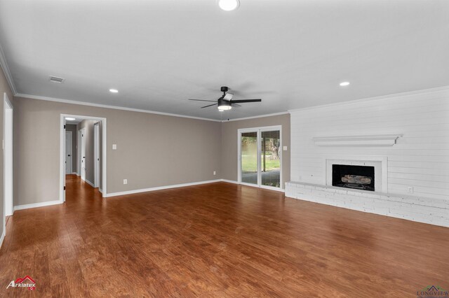 404 Pinewood, Marshall, TX 75672 - unfurnished living room with ceiling fan, wood finished floors, crown molding, a brick fireplace, and recessed lighting