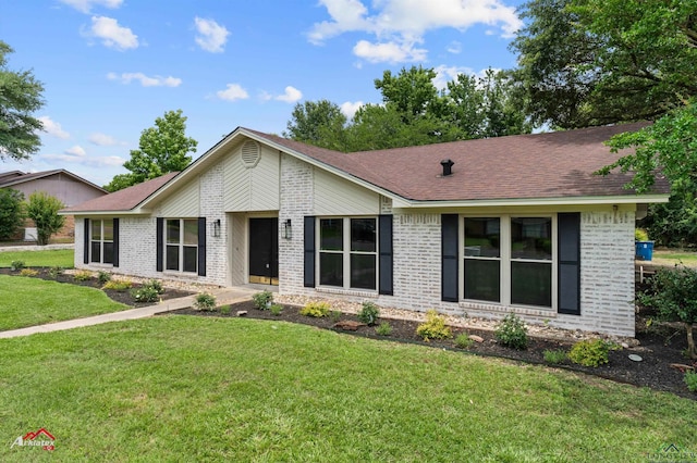 404 Pinewood, Marshall, TX 75672 - view of front of home with brick siding, a front lawn, and roof with shingles