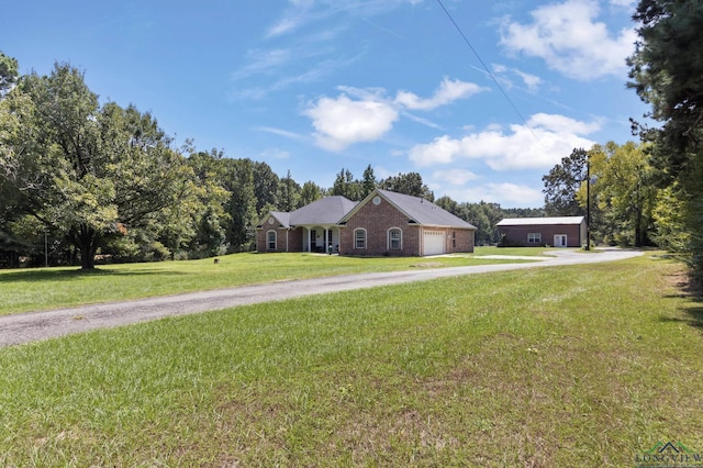 single story home featuring a garage and a front lawn