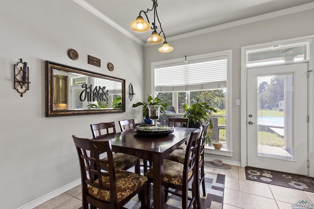 dining area featuring light tile patterned flooring and crown molding