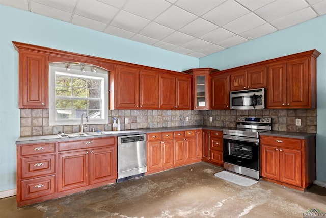 kitchen featuring appliances with stainless steel finishes, tasteful backsplash, a drop ceiling, and sink