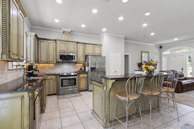 kitchen with a center island, crown molding, and appliances with stainless steel finishes