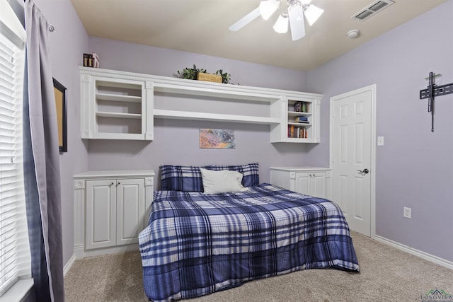 bedroom featuring light colored carpet and ceiling fan