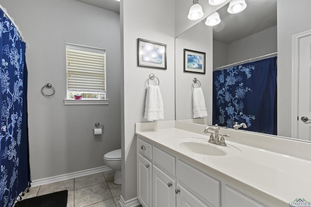 bathroom with tile patterned flooring, vanity, and toilet