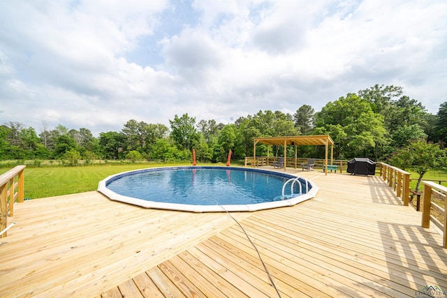 view of swimming pool featuring a gazebo, grilling area, a yard, and a wooden deck