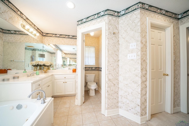 bathroom with toilet, vanity, tile patterned floors, and a bathing tub