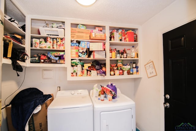 clothes washing area featuring separate washer and dryer, laundry area, and a textured ceiling