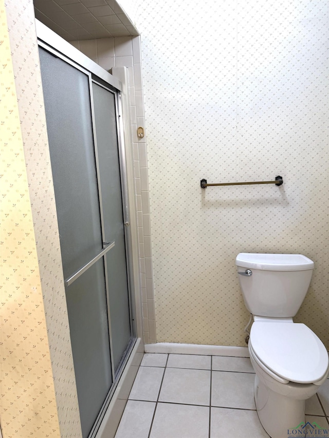 bathroom with toilet, tile patterned floors, and an enclosed shower