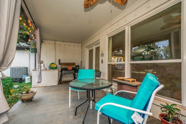 view of patio / terrace featuring area for grilling, central AC unit, and ceiling fan