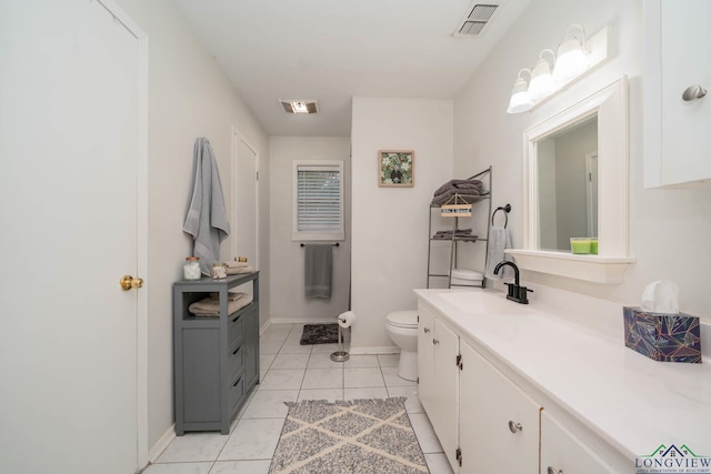 bathroom with tile patterned flooring, vanity, and toilet