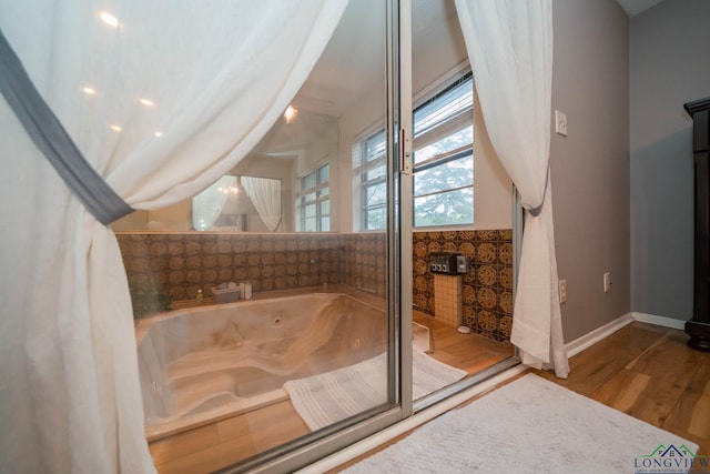 bathroom featuring a bathtub and hardwood / wood-style flooring