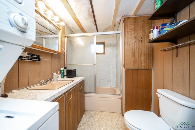 full bathroom with wooden walls, toilet, vanity, and combined bath / shower with glass door