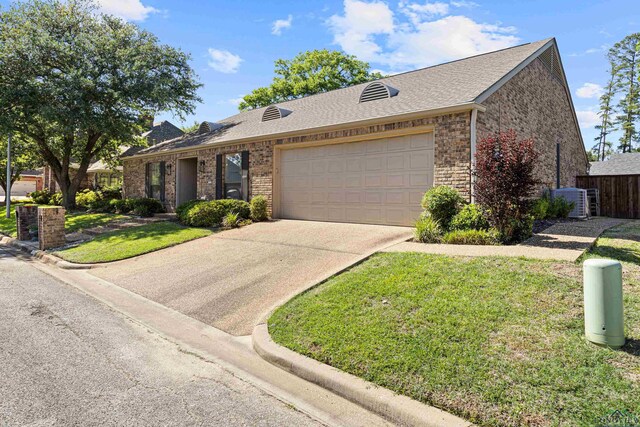 single story home featuring a garage, brick siding, concrete driveway, and a front yard