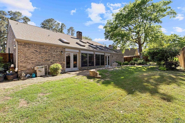 back of house with french doors, brick siding, a chimney, and a shingled roof