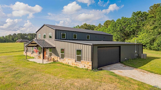 view of front of property featuring dirt driveway, board and batten siding, a front lawn, metal roof, and central air condition unit