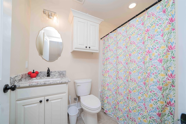 bathroom with vanity, toilet, tile patterned flooring, and curtained shower
