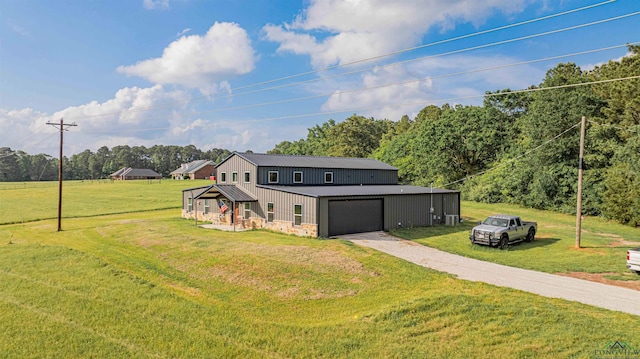 view of front facade with driveway, a front yard, and an attached garage