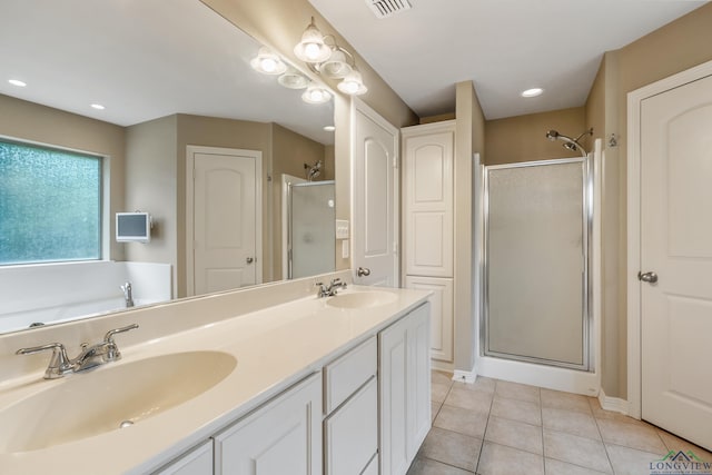 bathroom featuring an enclosed shower, vanity, and tile patterned floors