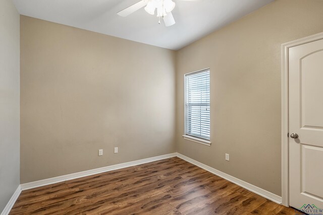 empty room with dark wood-type flooring and ceiling fan