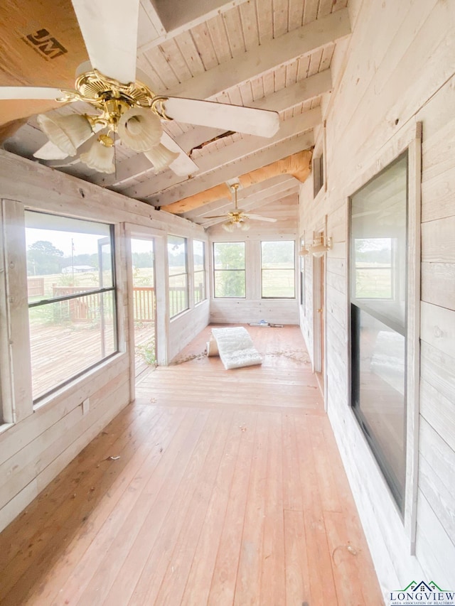 unfurnished sunroom featuring lofted ceiling with beams and wooden ceiling