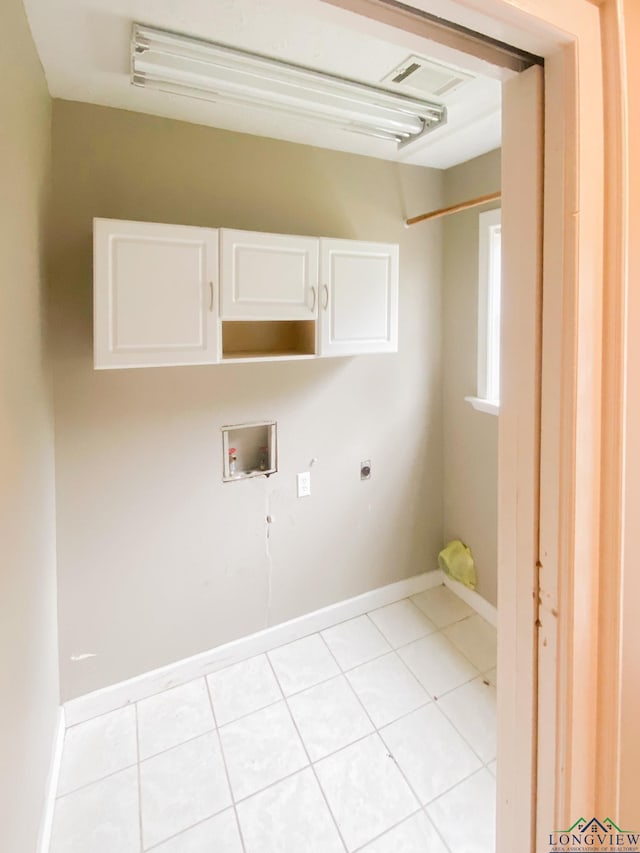 clothes washing area with cabinets, washer hookup, light tile patterned floors, and hookup for an electric dryer