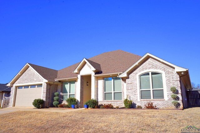 single story home featuring a front yard and a garage