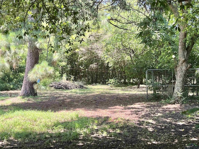 406 Campbell St, Daingerfield, TX 75638 - view of yard with a wooded view