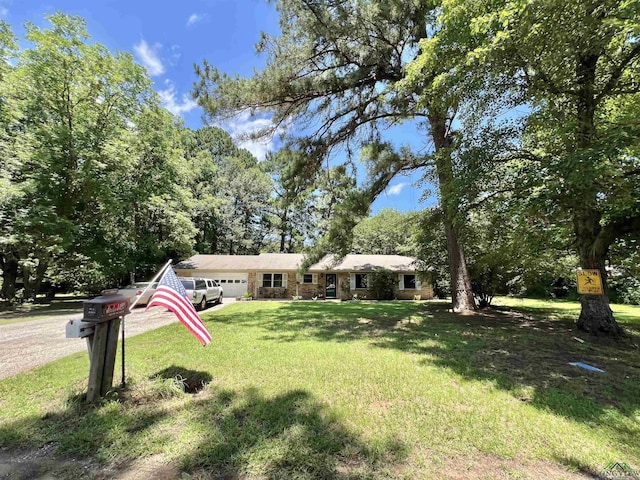 406 Campbell St, Daingerfield, TX 75638 - ranch-style house with an attached garage and a front yard