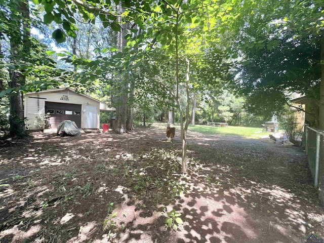 406 Campbell St, Daingerfield, TX 75638 - view of yard featuring a detached garage and an outbuilding