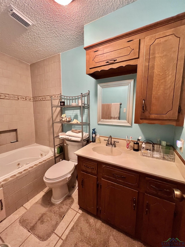 406 Campbell St, Daingerfield, TX 75638 - bathroom featuring a jetted tub, vanity, a textured ceiling, and tile patterned flooring